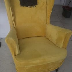 Sofa Chair from Ikea. Red in color with a yellow cover

STRANDMON
Wing chair, Tommaboda brown-red
