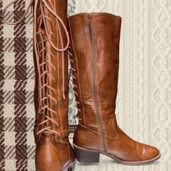 Brown leather knee high boots with lace up detail