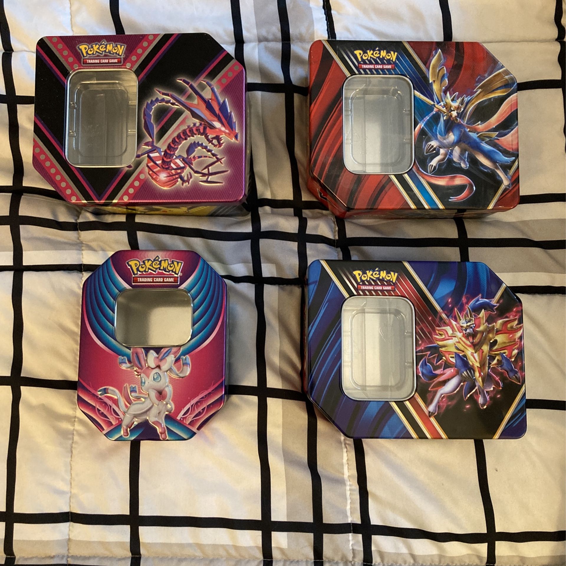4 empty Pokémon Card Tins