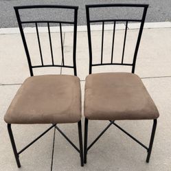 Selling 2 chairs with suede stools.