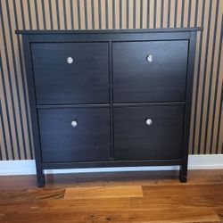 IKEA Hemmes Shoe Cabinet
Dark brown freestanding shoe storage cabinet features four flip-down compartments for organization
