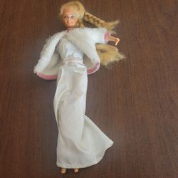 Vintage 80s Mattel Barbie doll the Superstar era part of Designer 
Collection. The doll is wearing a white gown with a matching white fur 
https://off