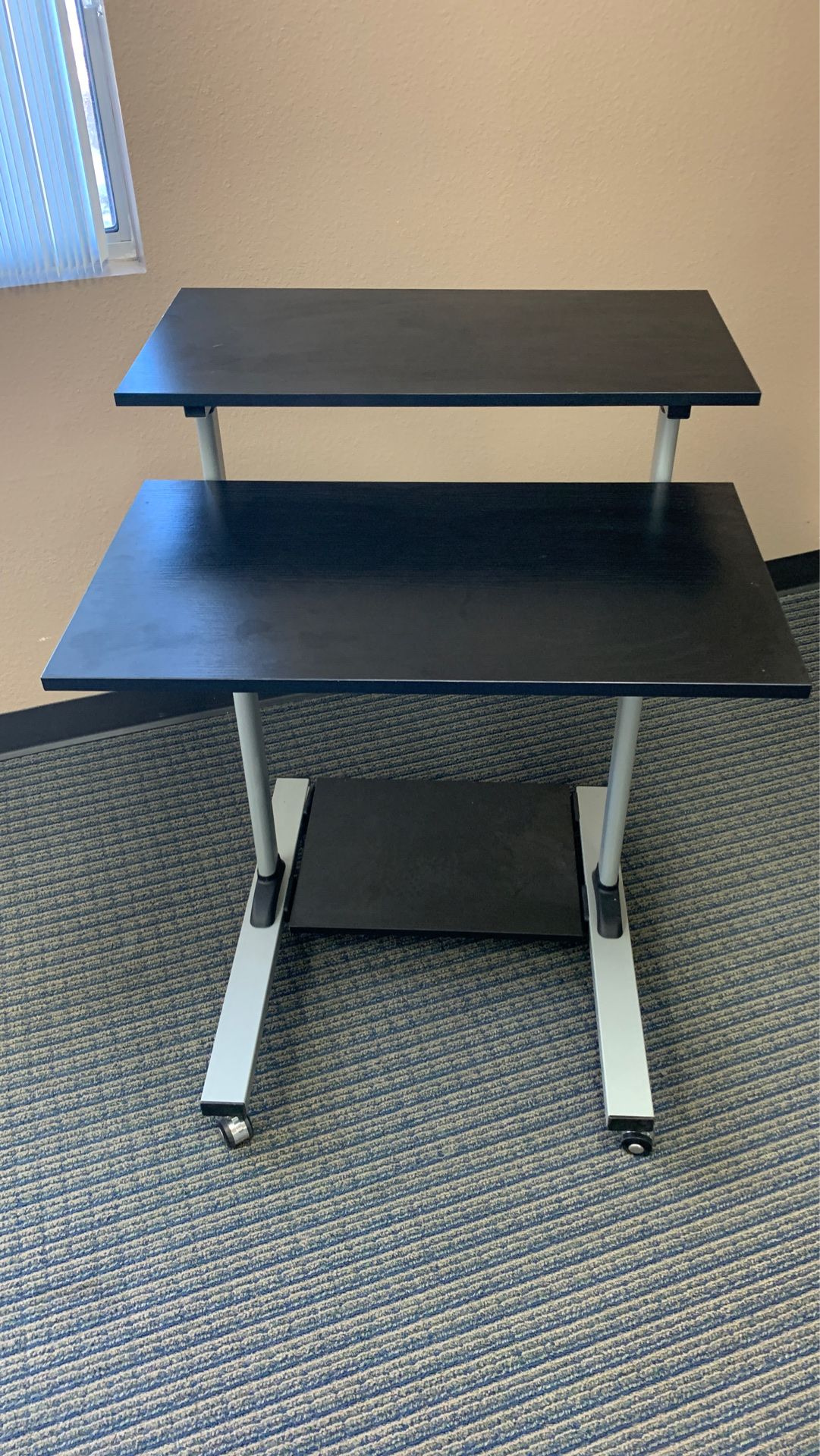 Adjustable rolling stand desk.