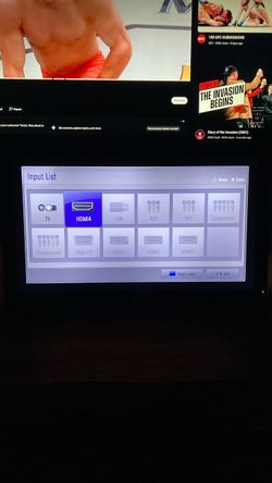 32 inch LG TV with a Denon Heos soundbar and wireless subwoofer