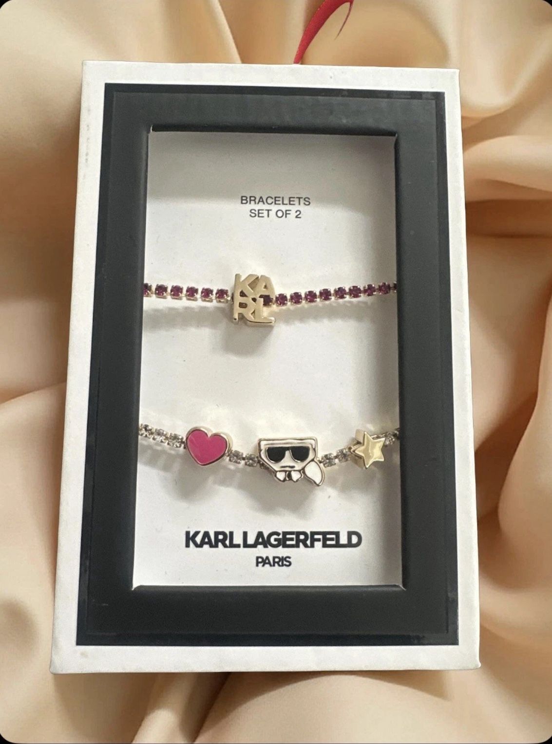 Karl Lagerfeld Paris gold-tone And Pink  2-piece set of crystal slider charm bracelets. 