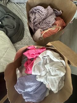 2 grocery bags of baby clothes