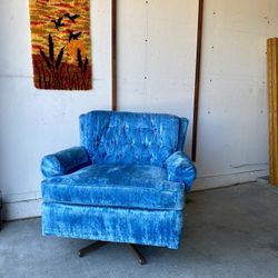 Mid Century swivel rocker chair upholstered in blue velvet