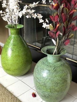 Decorative Green Metal Vases with flowers.