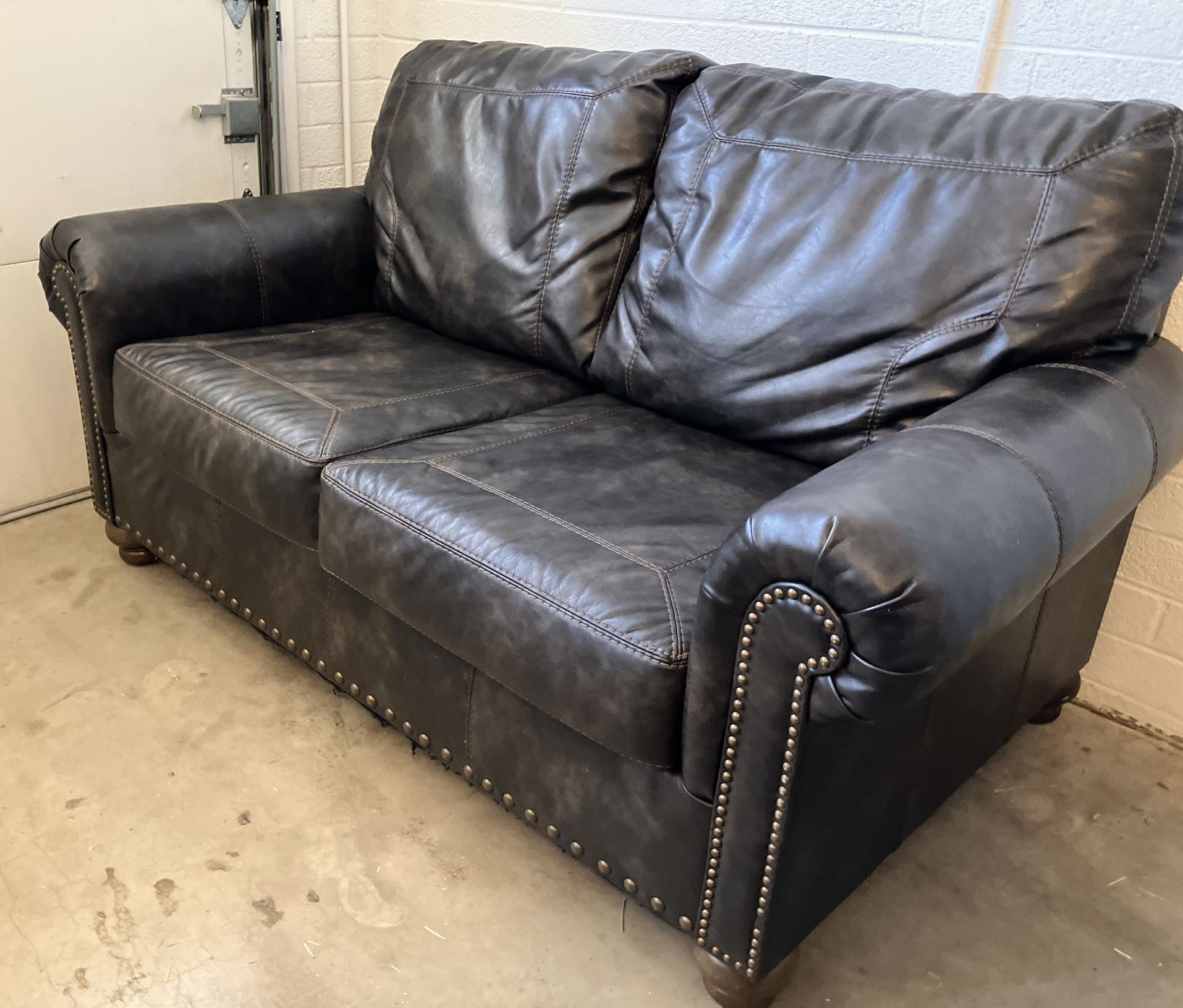 Ashley Furniture Nicorvo Brown Nailhead Trim Leather Loveseat Couch