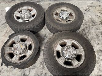 3rd gen Dodge Ram chrome aluminum 17-inch rims caps and old tires 8 lug