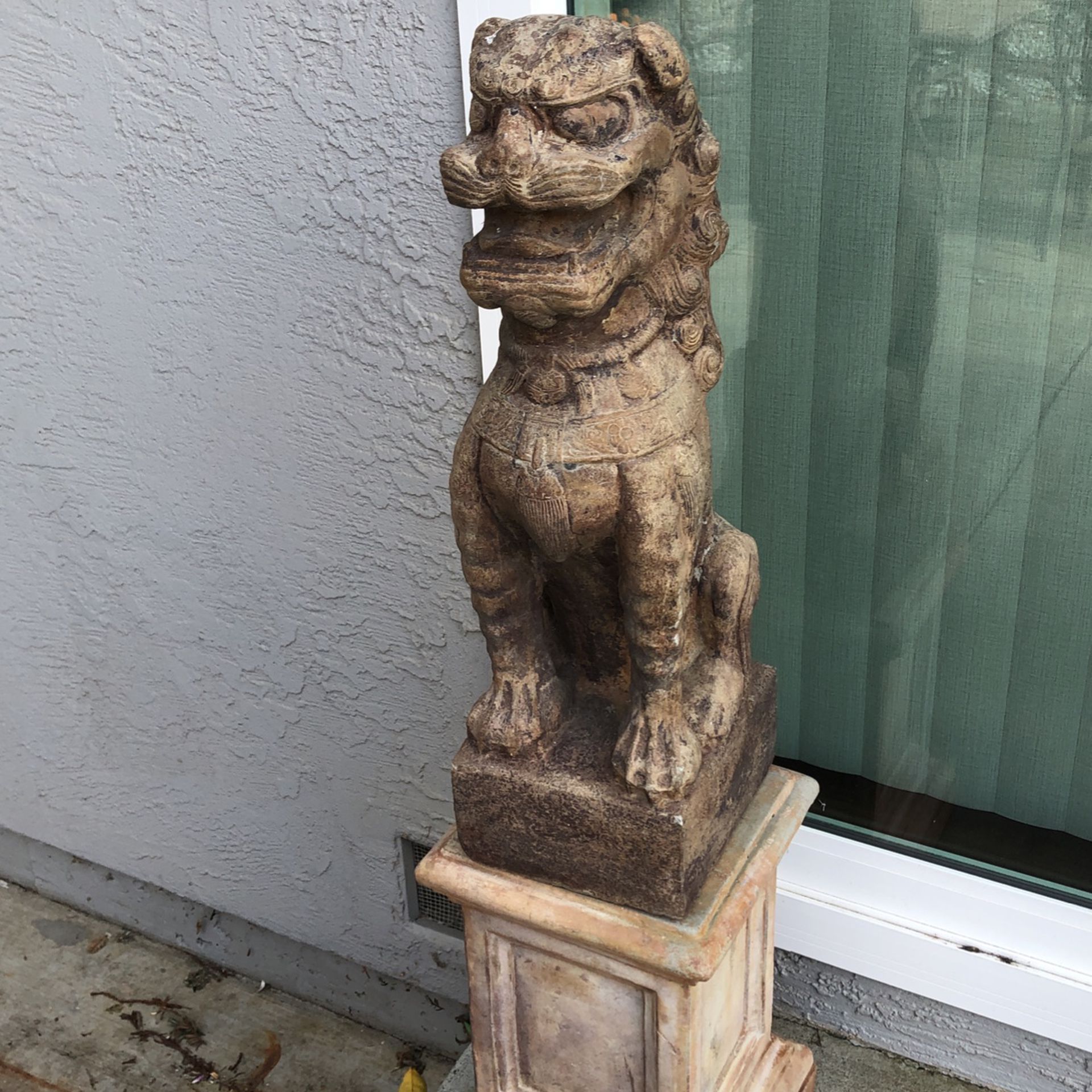 Two lion statues with two stands guard your yard