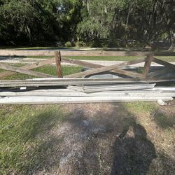 Seven pieces of 16 foot gutters recently removed with downspouts hangers
