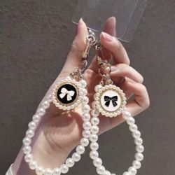 Elegant Pearl Wrist Phone Strap with Bow Charm Stylish & Practical