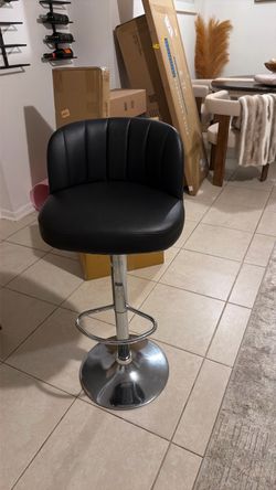 The chair black And sofa beige the table is