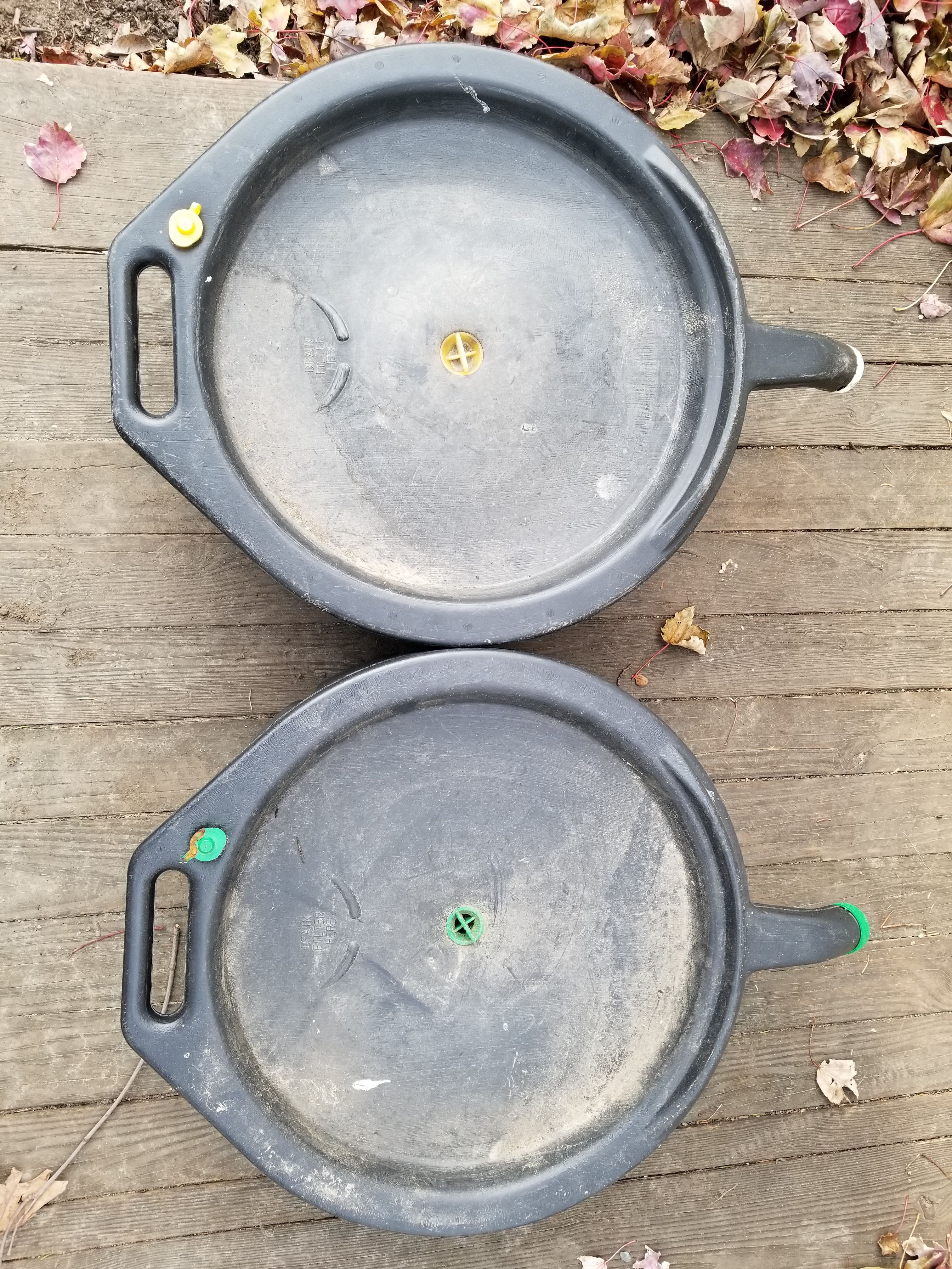 Used motor oil collection containers with spout.