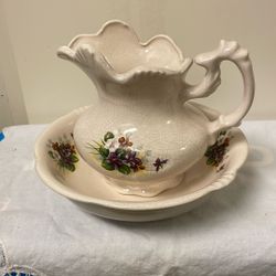 vintage ceramic pitcher and basin set, often used as a decorative item or as a small-scale washbasin set.  The set features a creamy, off-white color 