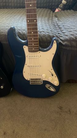 Guitars black and one blue. Brands on picture