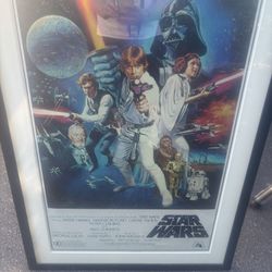 A framed poster of the classic 1977 Star Wars film.