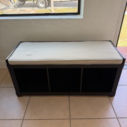 Dark brown bench with beige cushion