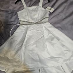 A white dress for a girl Size 8 This is good for a wedding or a baptismal dress. Even Easter brand New.
