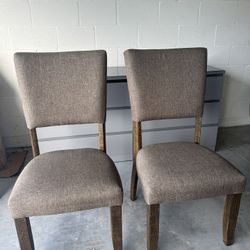 Two Chairs With Fabric Cushions And Wooden Legs