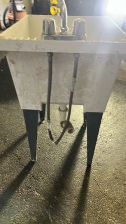 Utility tub with faucet