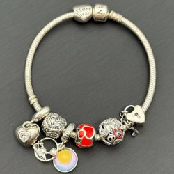 Jewelry Pandora 925 sterling silver gold  7.5” charm bracelet with 7 charms