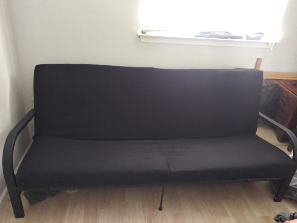 Black futon with metal arm rests with 6" convertible bed currently selling at retail store for $120