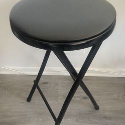 Black padded folding stool chair