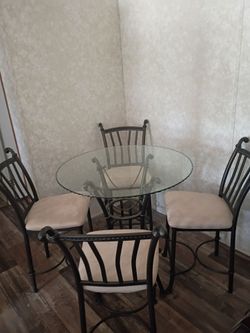 4 chairs with glass table