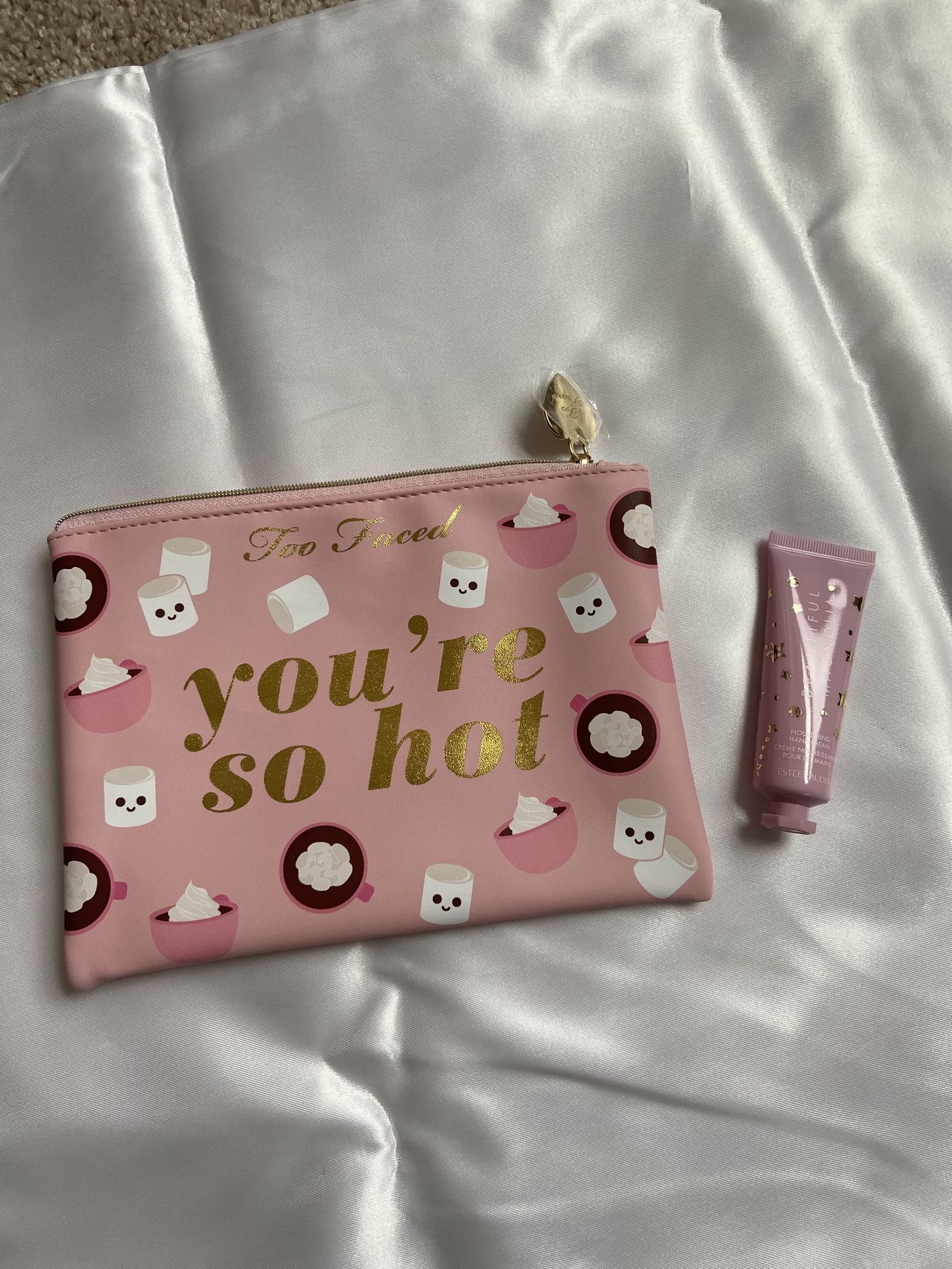 Too faced makeup pouch & Estée Lauder hand