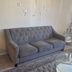 A Set Of Two Gray Couches