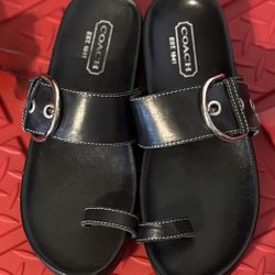 Coach black leather slide sandals with buckle detail. Size 7