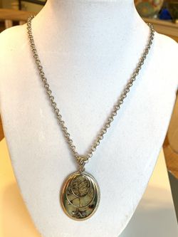 Silver tone necklace with simulated mother of pearl pendant