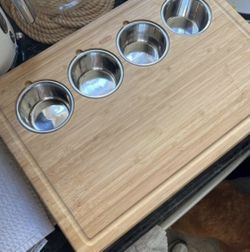 Bamboo cutting board with three stainless steel bowls. 13x19 inches