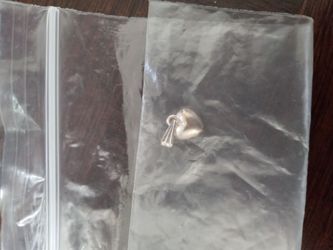 Small silver heart shaped decorative necklace piece