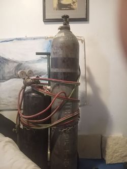 Acetylene and nitrogen tanks full with gauges caps dolly cart hoses cutting torches one cutting tools bottles are 95% full