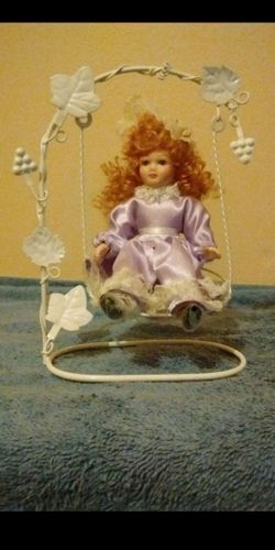 ANTIQUE doll on a swing