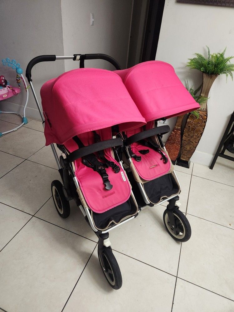 Pink Double Stroller With Child Seat In Back