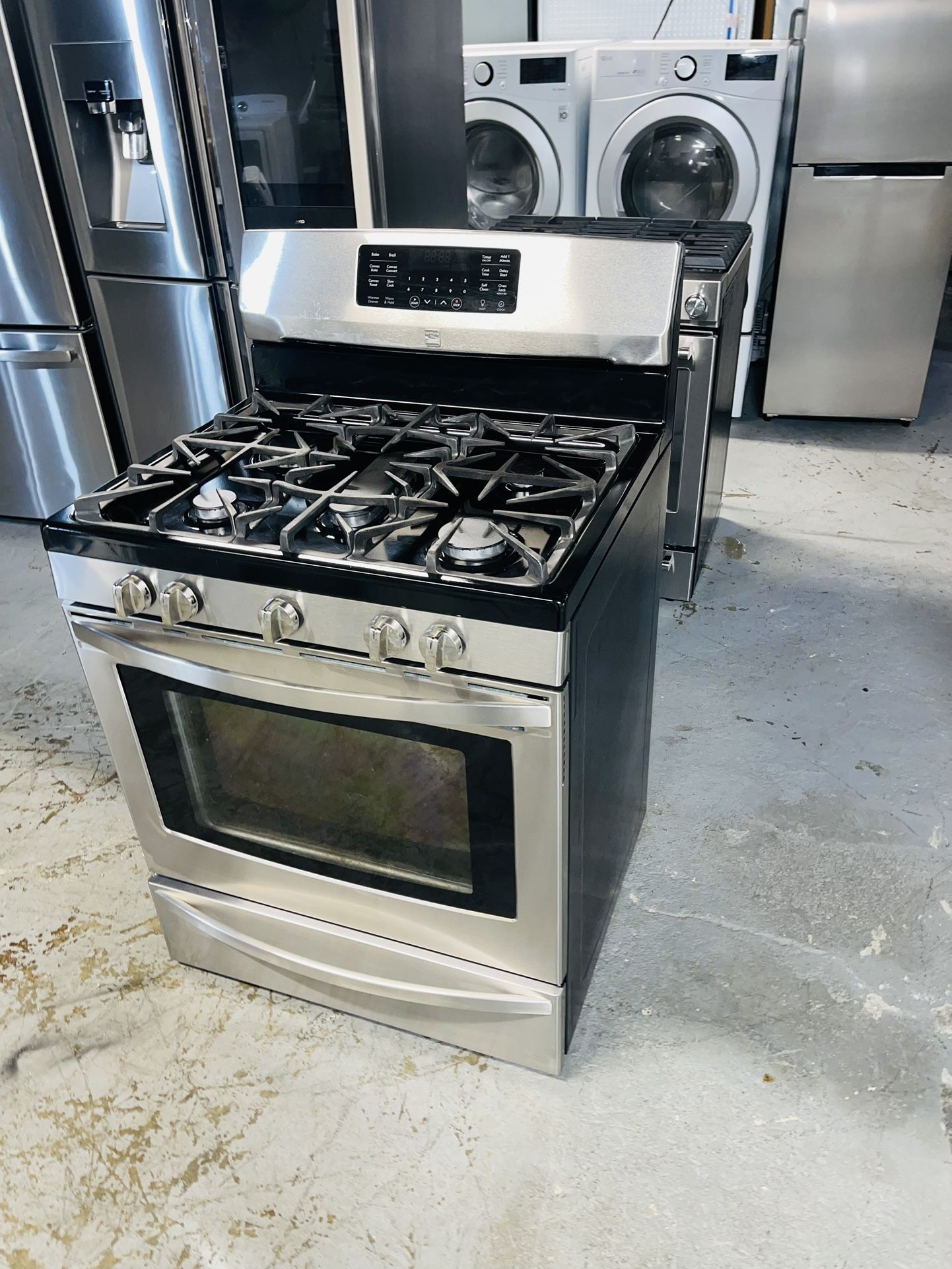Kenmore stainless steel stove, 30 inches wide, with a receipt for a 60-day warranty.