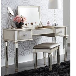 Wood with mirrored accents. Lift up mirror and storage center. Pu upholstered stool,