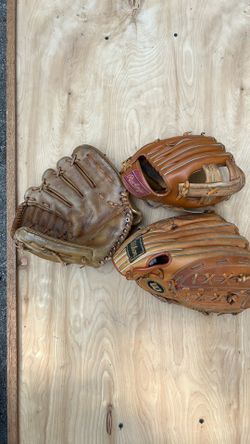 Three leather baseball gloves
