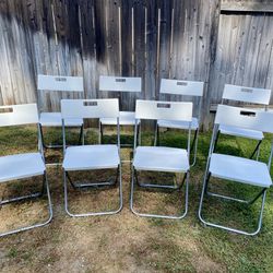8 White Folding Chairs