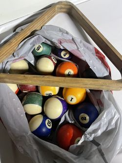 Pool Balls And A Pool Stick 