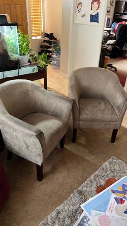 Two beige microfiber chairs with dark wood legs