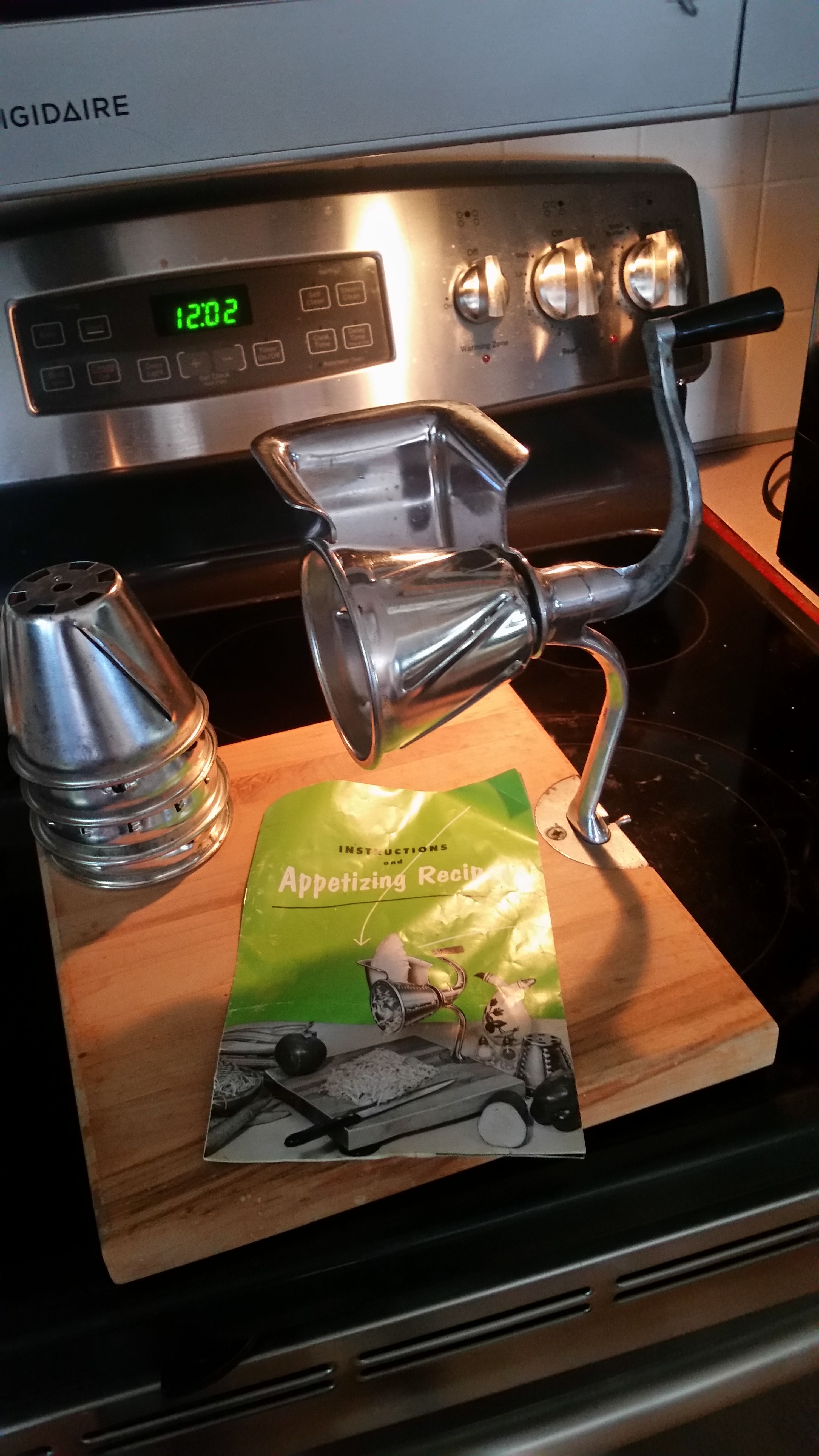 Vintage Griscer Deluxe Manual Food Cutter, processor, grinder, shredder, with 5 cutting cones and very nice wooden stand.