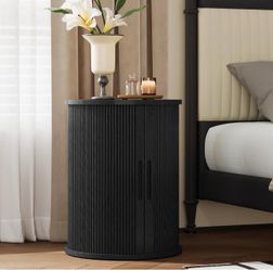 Black Oval Nightstand with Fluted Cabinet Door