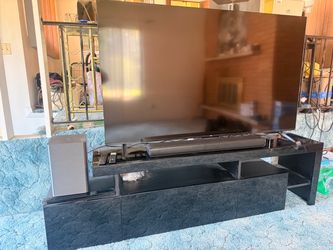 65 in 4k UHD smart tv, tv stand, and soundbar and subwoofer