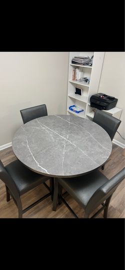 Round faux marble counter height dinning set with 4 chairs