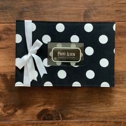 14.5” x 9.5”. Fabric covered photo album.  Photo window.  White satin bow.  Four slip in photo slots per side.  New with tag.